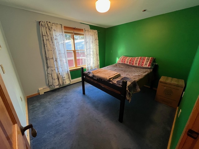 carpeted bedroom featuring a baseboard heating unit