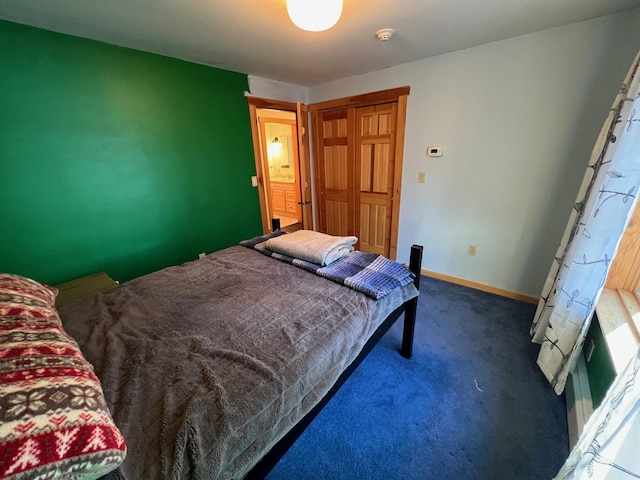 bedroom featuring a closet and dark colored carpet