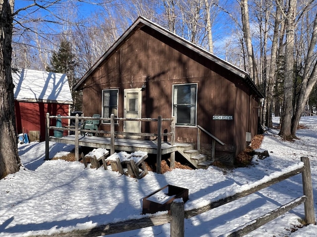 snow covered property featuring a deck