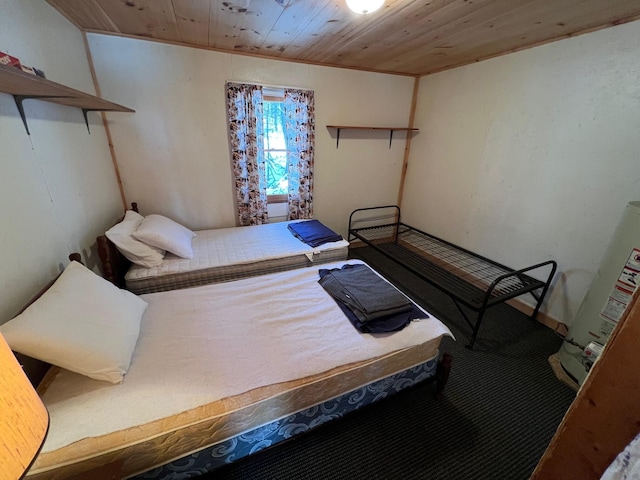 bedroom featuring wood ceiling and water heater