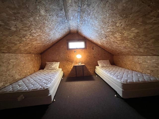 bedroom with carpet and vaulted ceiling