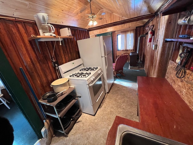 kitchen with wooden walls, white gas range, lofted ceiling, and ceiling fan