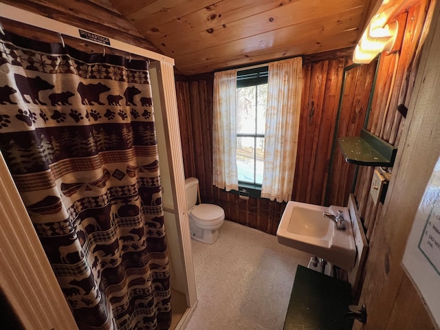 bathroom with sink, wooden ceiling, wood walls, lofted ceiling, and toilet