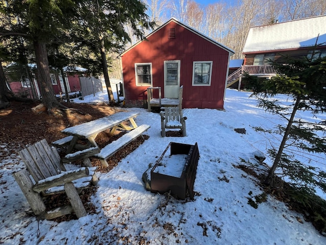 view of snow covered back of property