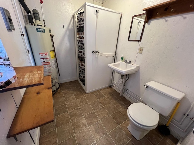 bathroom featuring toilet, sink, walk in shower, and water heater