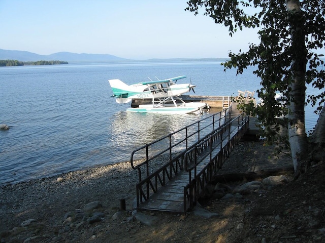 view of dock featuring a water and mountain view