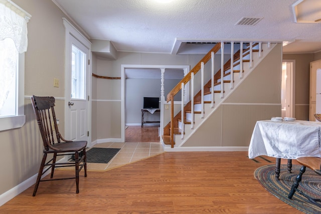 entryway with hardwood / wood-style flooring and a textured ceiling