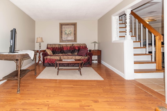 living room with hardwood / wood-style floors and ceiling fan