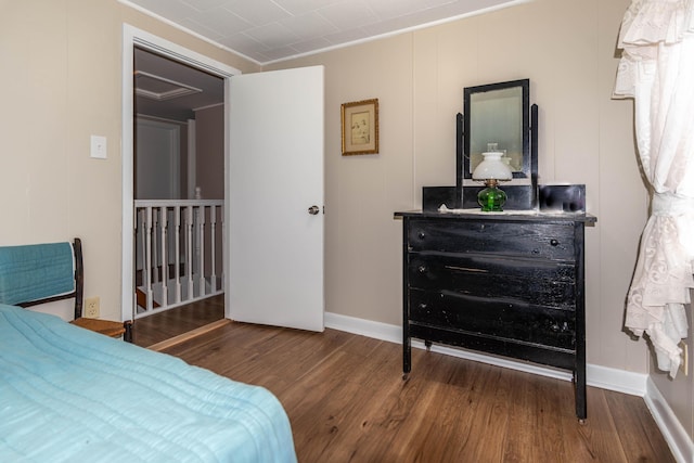 bedroom with hardwood / wood-style flooring and crown molding