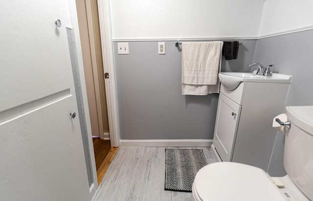 bathroom featuring hardwood / wood-style floors, vanity, and toilet