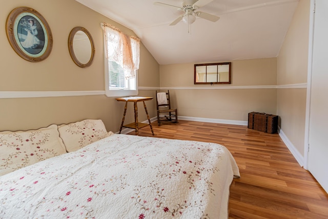 bedroom featuring ceiling fan, wood-type flooring, and lofted ceiling