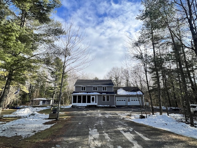 view of front of house with a sunroom and a garage