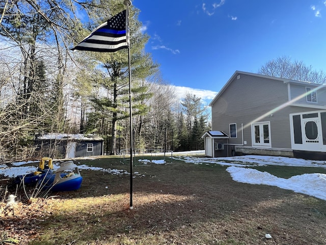 view of property exterior with french doors and a storage shed