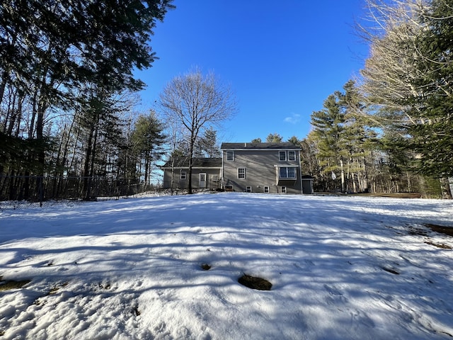 view of snow covered rear of property