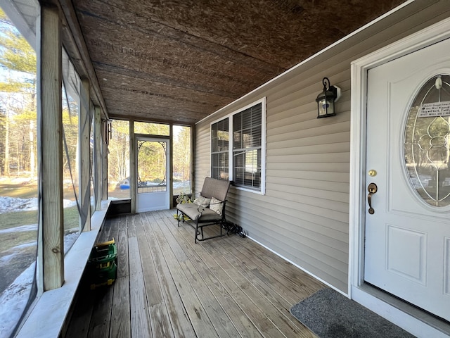 unfurnished sunroom with wood ceiling