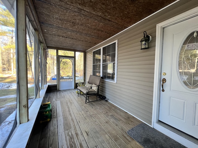 unfurnished sunroom featuring wood ceiling