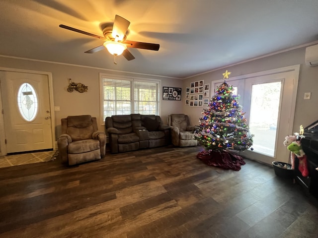 living room with ceiling fan, plenty of natural light, crown molding, and dark hardwood / wood-style floors