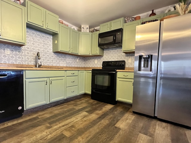 701 Stetson Rd, Exeter, ME 04435 - kitchen featuring green cabinetry, black appliances, dark wood finished floors, and decorative backsplash