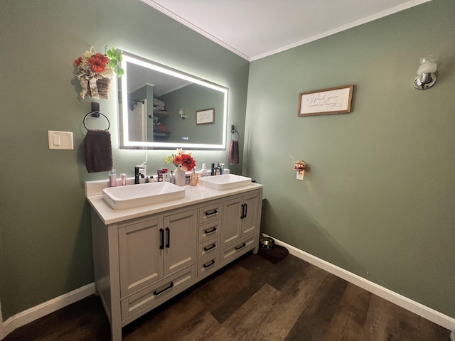 bathroom featuring vanity, wood-type flooring, and ornamental molding