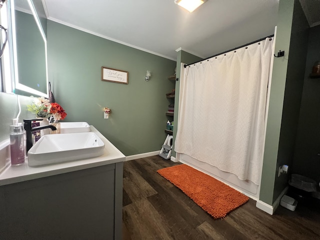 bathroom featuring shower / bath combo with shower curtain, hardwood / wood-style floors, vanity, and ornamental molding