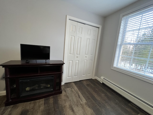 701 Stetson Rd, Exeter, ME 04435 - unfurnished bedroom with a baseboard radiator, dark wood-type flooring, and a closet