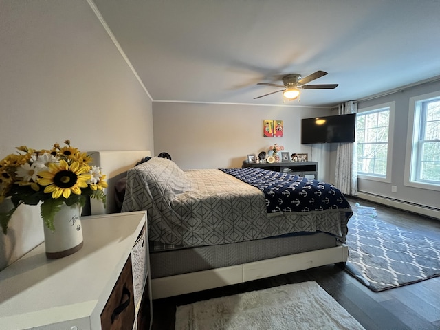 701 Stetson Rd, Exeter, ME 04435 - bedroom with dark wood-style flooring, a ceiling fan, a baseboard radiator, and ornamental molding