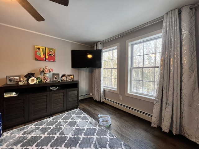 bedroom featuring ceiling fan, crown molding, a baseboard radiator, and dark hardwood / wood-style floors