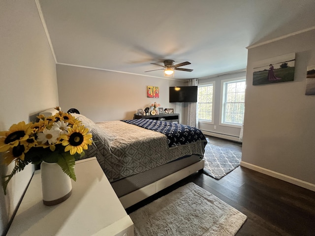 bedroom featuring baseboard heating, ceiling fan, crown molding, and dark hardwood / wood-style floors