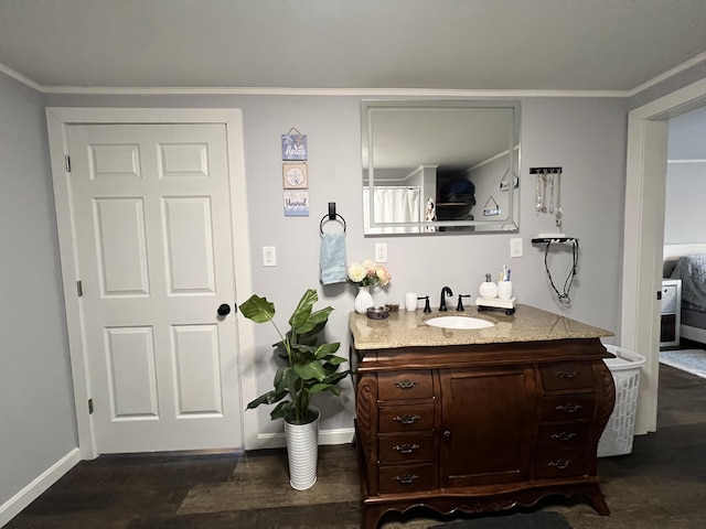 bathroom featuring vanity, wood-type flooring, and crown molding