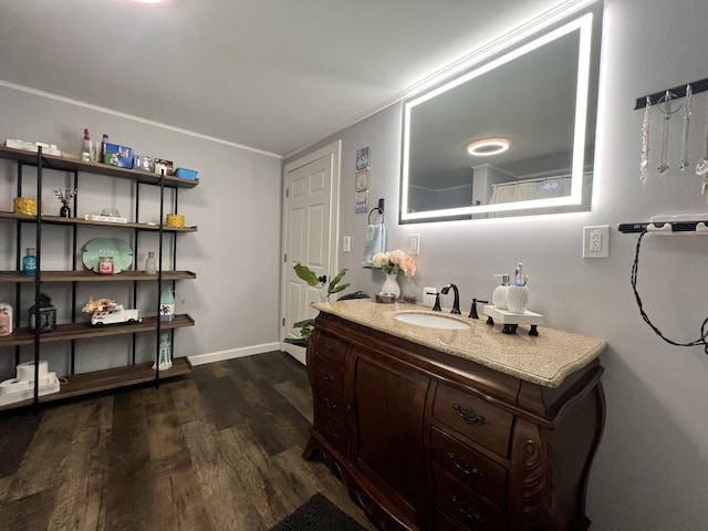 bathroom with vanity, ornamental molding, and hardwood / wood-style flooring