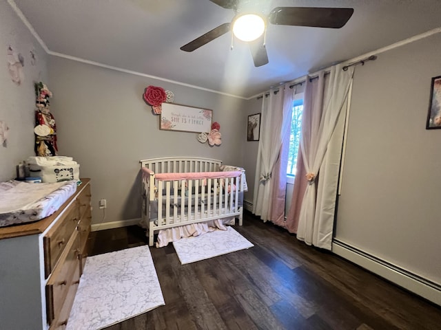 701 Stetson Rd, Exeter, ME 04435 - bedroom with a baseboard radiator, a nursery area, wood finished floors, ceiling fan, and ornamental molding