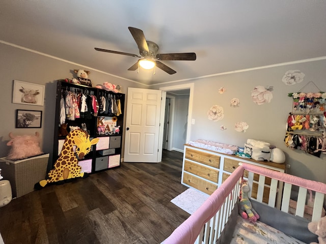 bedroom with crown molding, ceiling fan, a closet, and dark wood-type flooring