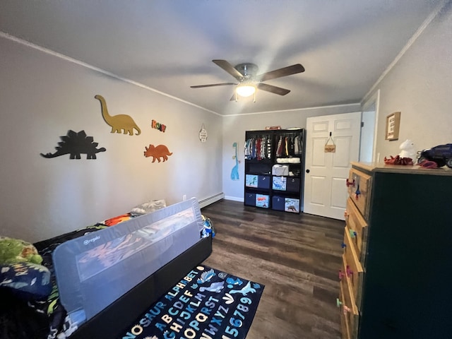 bedroom featuring baseboard heating, ceiling fan, dark hardwood / wood-style flooring, and ornamental molding