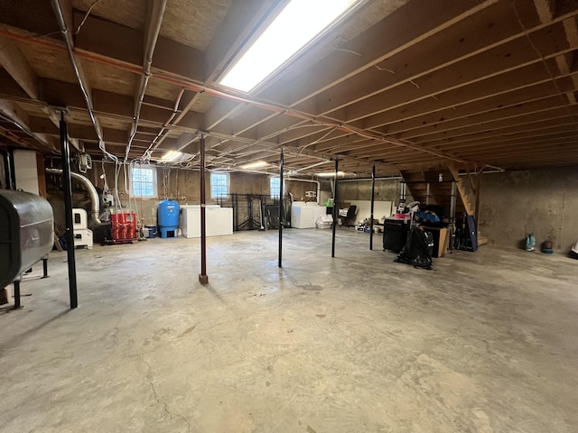 701 Stetson Rd, Exeter, ME 04435 - below grade area with washing machine and dryer, oil tank, a water pressure tank, and a heating unit