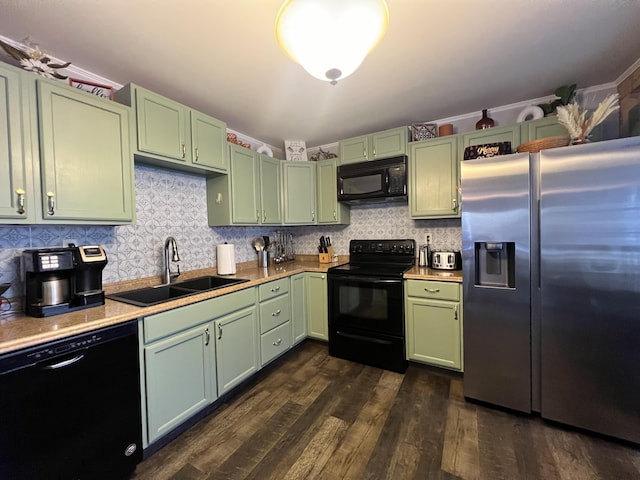 kitchen featuring sink, black appliances, dark hardwood / wood-style floors, and green cabinetry