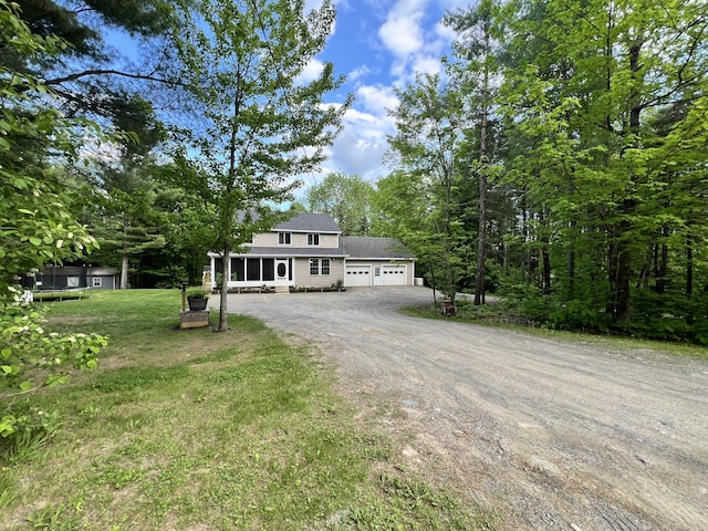 701 Stetson Rd, Exeter, ME 04435 - view of front of property featuring dirt driveway, an attached garage, a front lawn, a trampoline, and roof with shingles