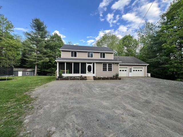 701 Stetson Rd, Exeter, ME 04435 - view of front of property featuring a sunroom, a garage, driveway, a front yard, and an outdoor structure