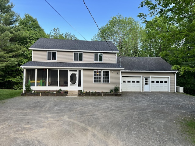 701 Stetson Rd, Exeter, ME 04435 - view of front of house featuring driveway, a sunroom, a garage, and a shingled roof