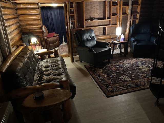 living room featuring wood-type flooring and rustic walls