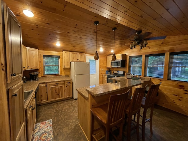 kitchen featuring a kitchen breakfast bar, wood ceiling, stainless steel appliances, vaulted ceiling, and a kitchen island