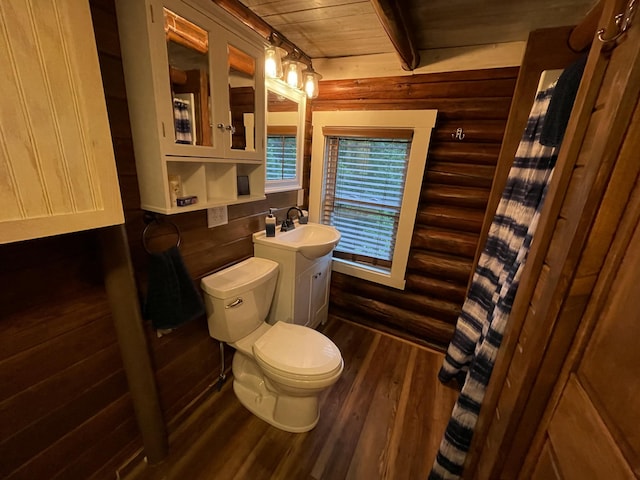 bathroom with hardwood / wood-style floors, vanity, wood ceiling, and log walls