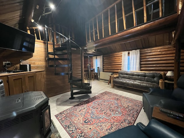 living room featuring log walls, lofted ceiling, light wood-type flooring, and wooden walls