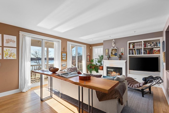 office space with built in features and light wood-type flooring