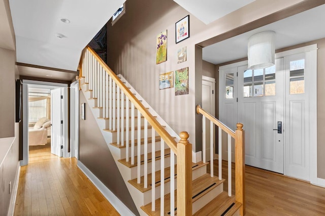 stairway with hardwood / wood-style floors