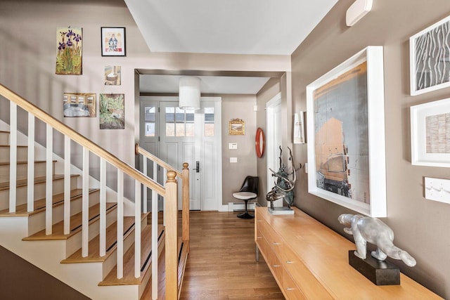 entryway with dark hardwood / wood-style floors and baseboard heating