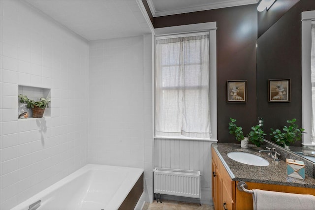 bathroom with crown molding, radiator heating unit, vanity, and a washtub