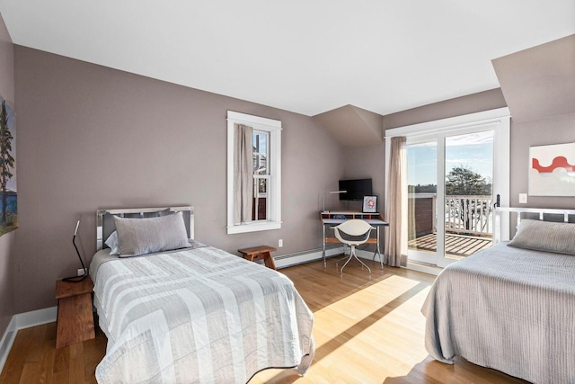 bedroom featuring wood-type flooring, access to outside, and a baseboard radiator