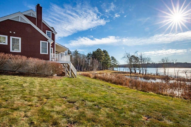 view of yard featuring a deck with water view