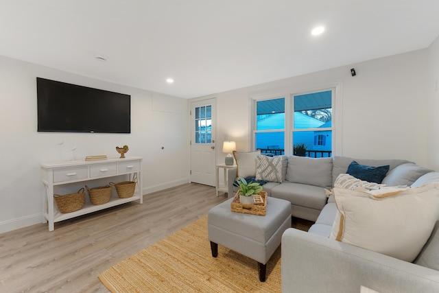 living room featuring light wood-type flooring and a wealth of natural light