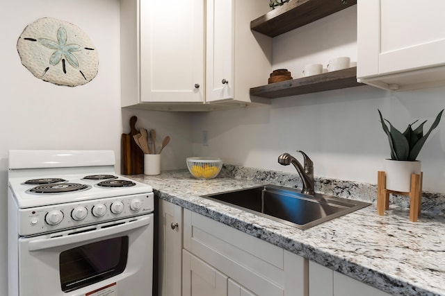 kitchen featuring sink, white cabinetry, white electric range, and light stone countertops